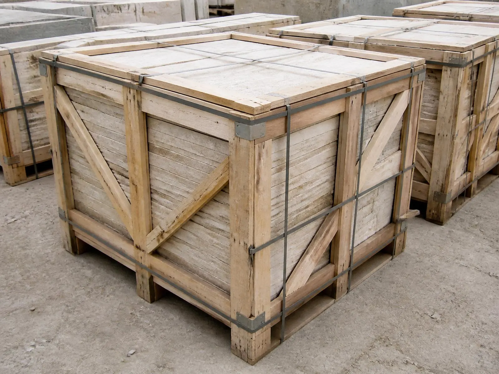 Seaworthy timber crates packed with stacked limestone, strapped and standing in the yard ready to load