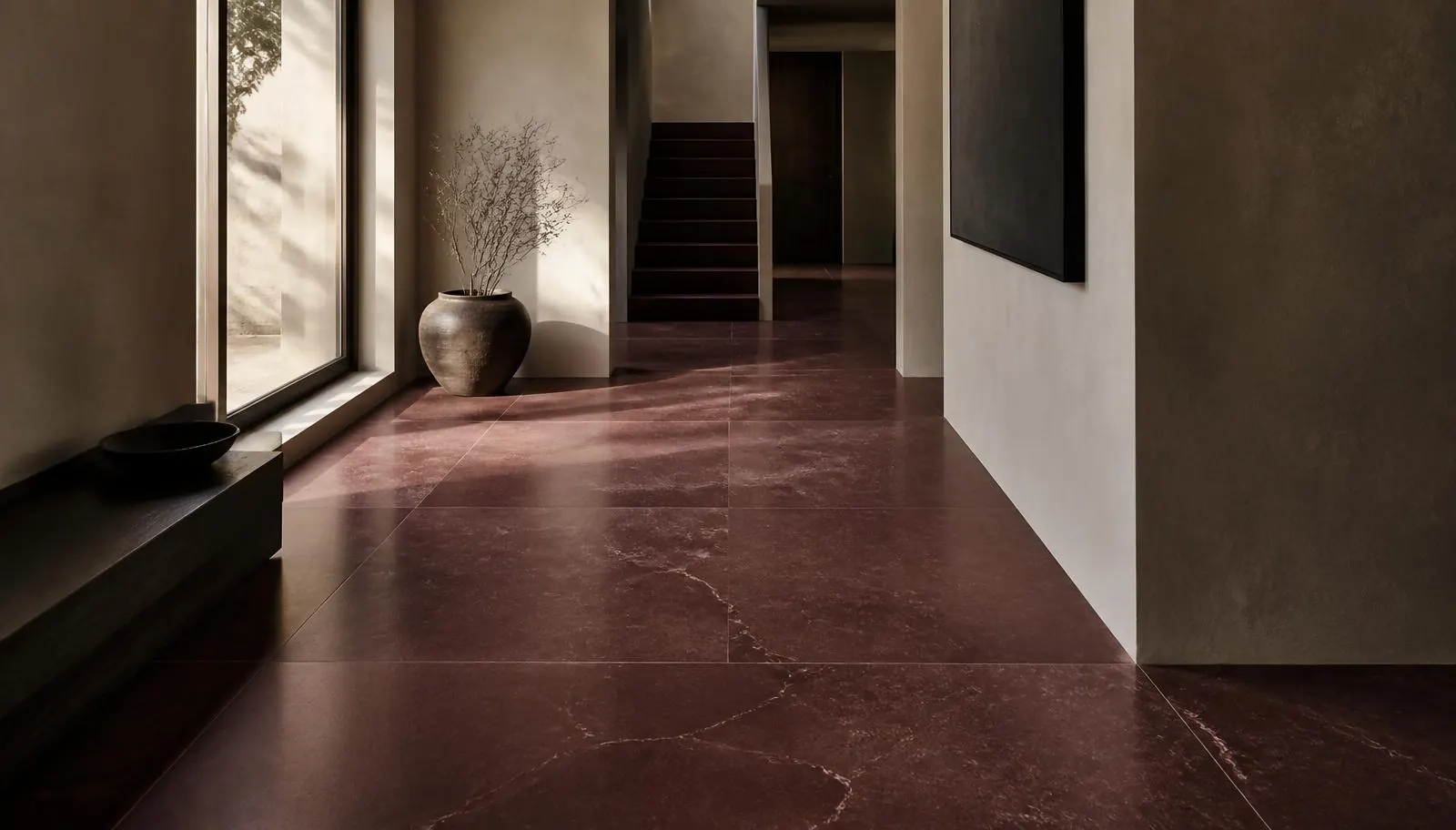 Indicative visualisation of a honed Shahabad limestone floor in a minimal hallway under raking daylight