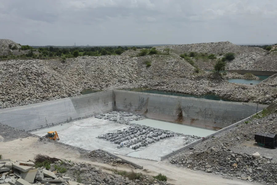 Overview of the quarry pit and the stepped limestone beds being worked