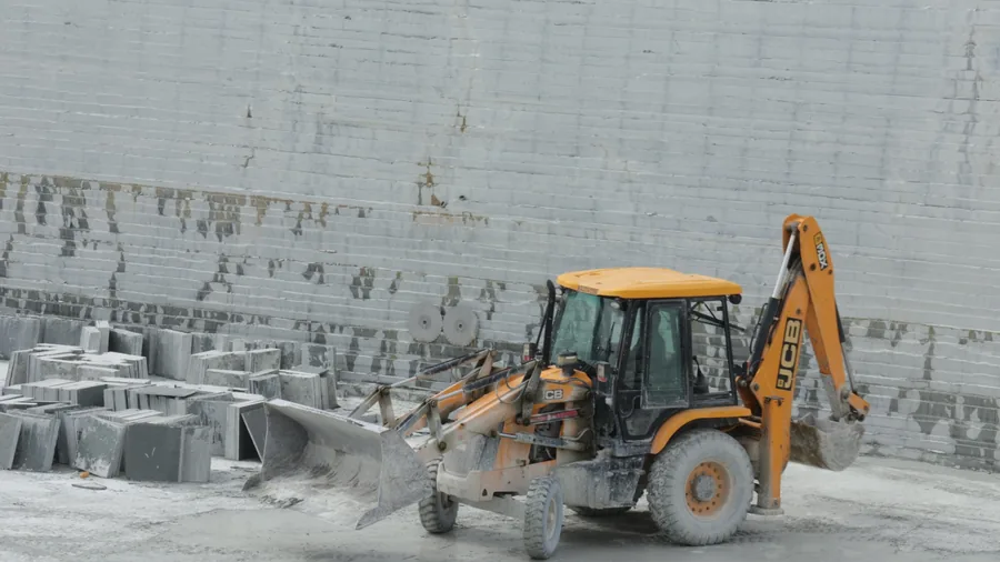 A loader working at the benched limestone face inside the quarry