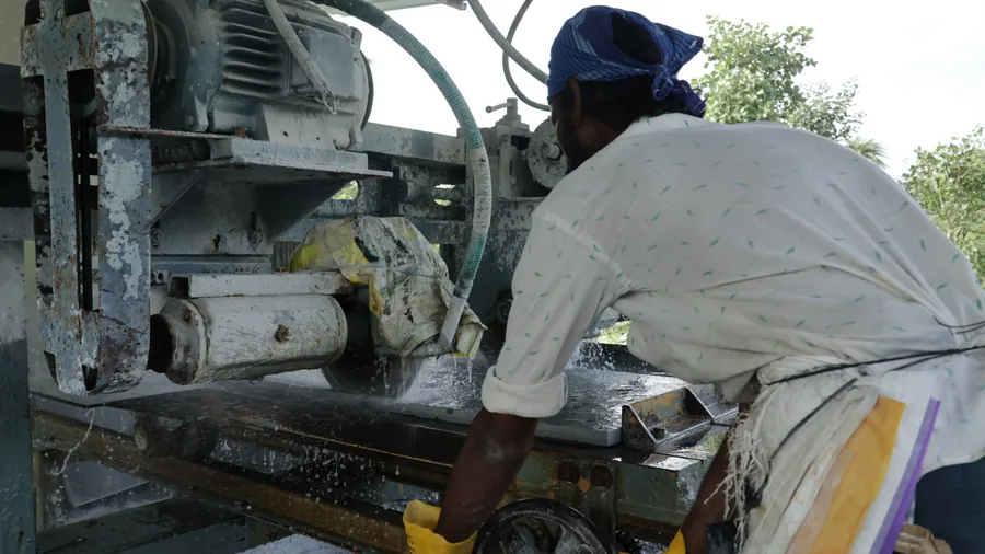 A finishing machine working the surface of Shahabad limestone at the yard